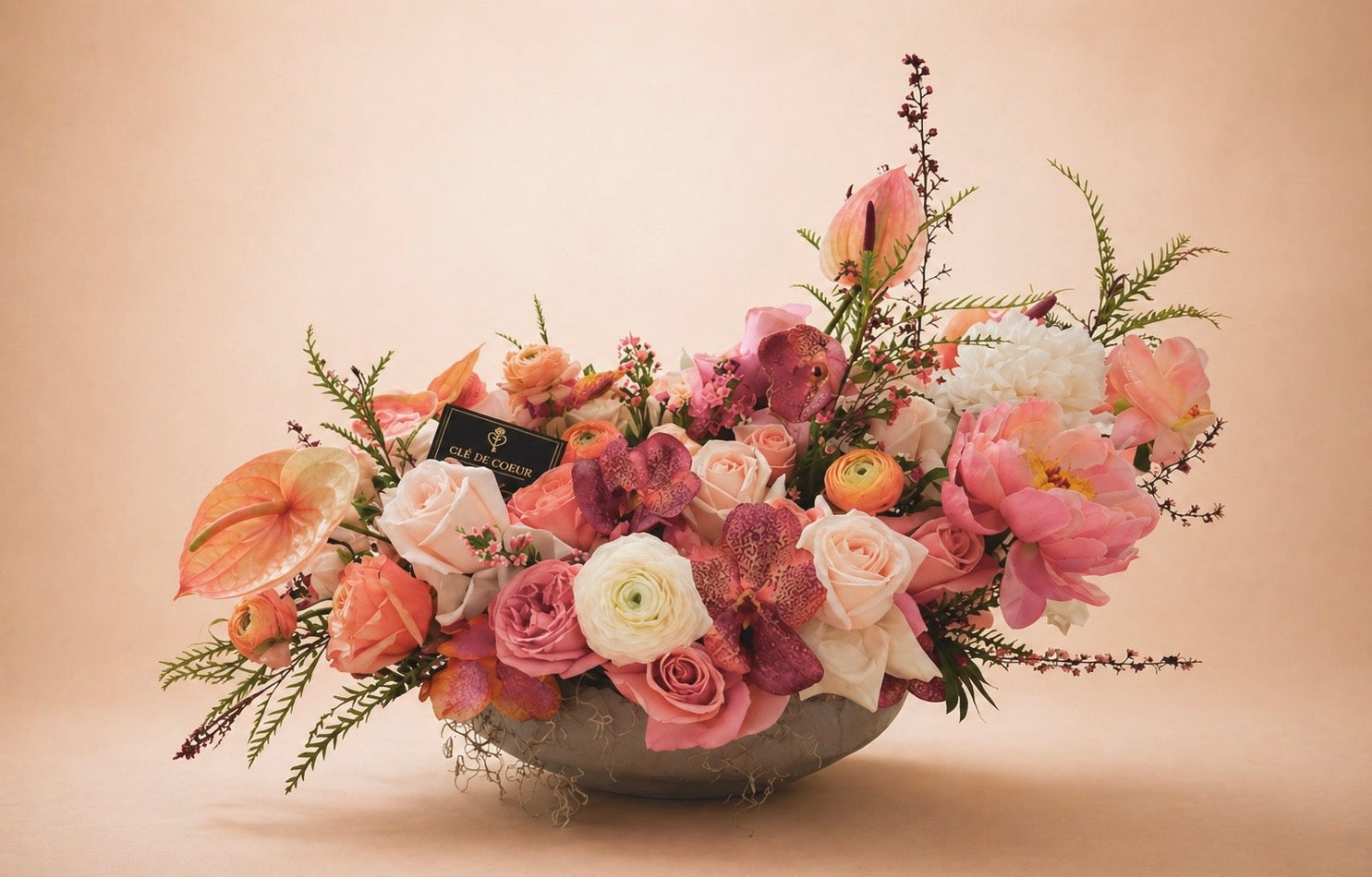 Floral arrangement in a bowl on a beige background